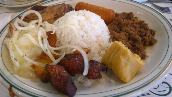 Cuban Classic Sampler (clockwise from 3 o'clock): picadillo ground beef, tamale, fried plantains, cassava, roast pork and croquette
